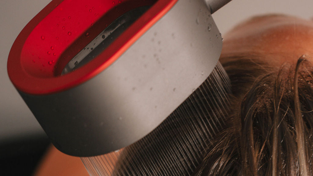 Person using befor flex filtered showerhead on a blurred background