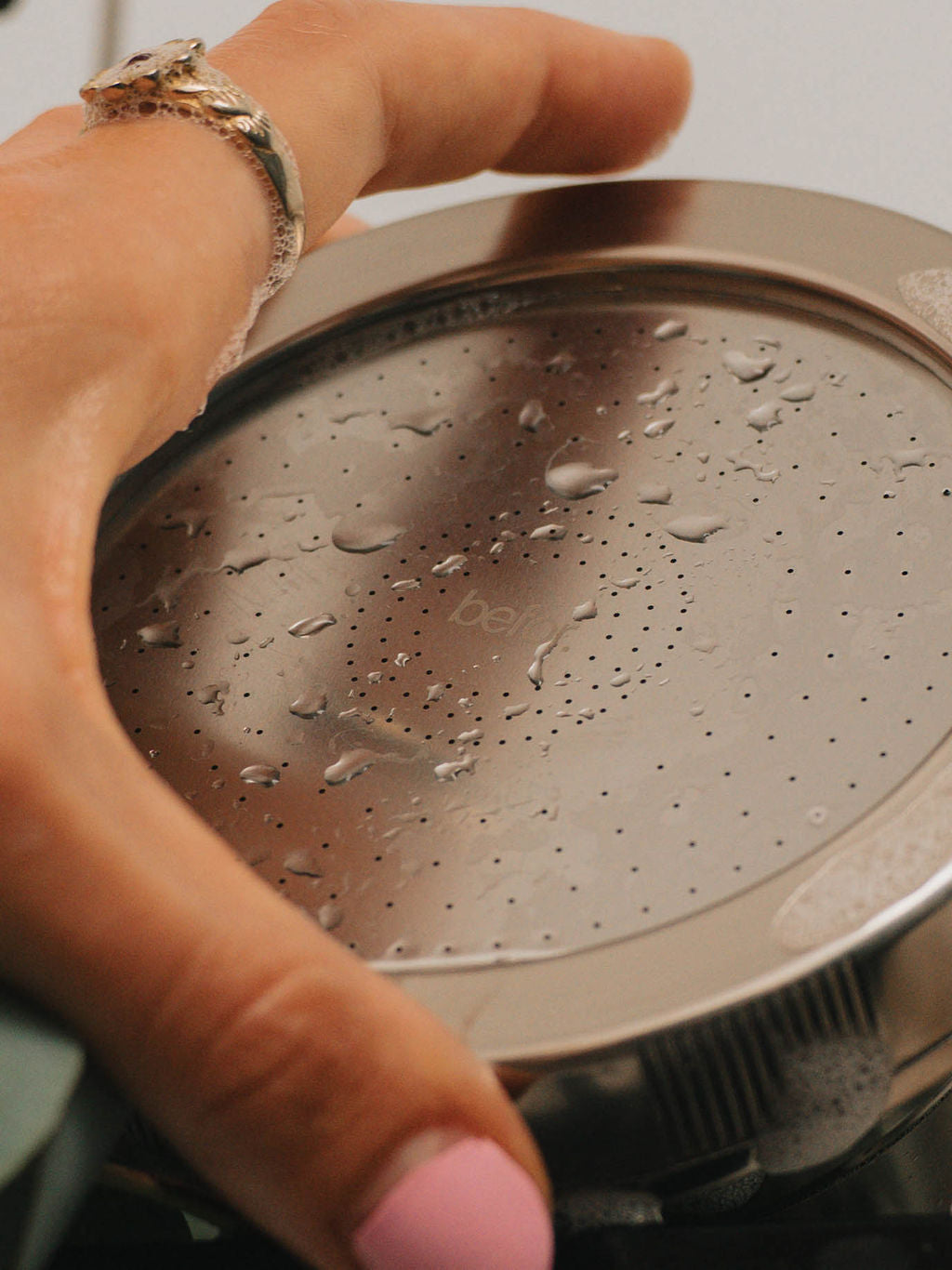 hand hold a befor filtered showerhead